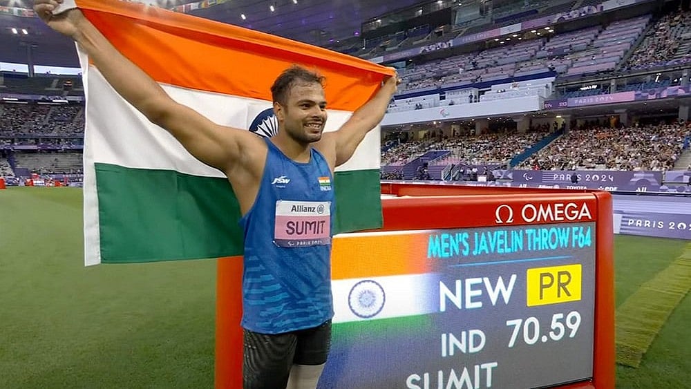 | Photo: PTI : 2024 Paris Paralympics: Sumit Antil poses for photographs after winning the gold medal in javelin throw F64 event